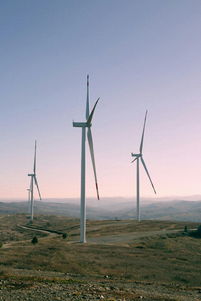 Scenic view of wind turbines in an open landscape during daytime, showcasing renewable energy.